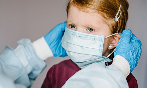 Picture of a child wearing a surgical mask