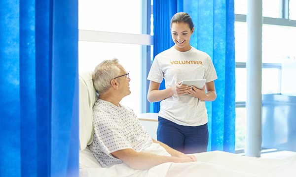 NHS volunteer with patient