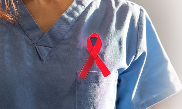 The HIV/Aids ribbon pinned on a nurse's uniform