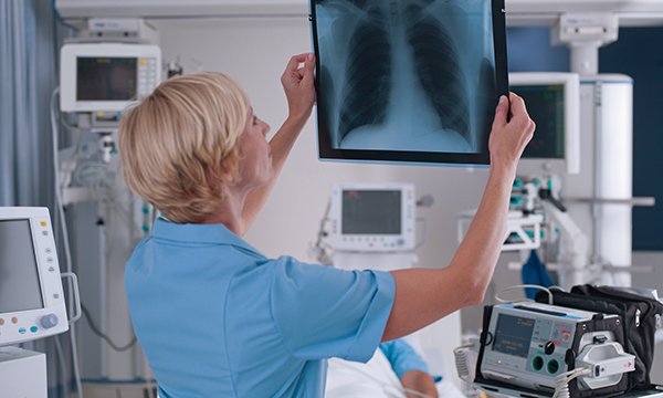 Nurse views lung X-ray