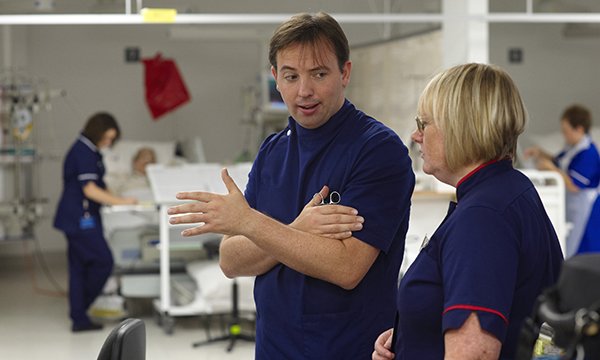 Picture shows medics having a conversation in a hospital ward. A new handbook reflects the expanded role of the modern matron and can be a guide for training and continuing professional development.