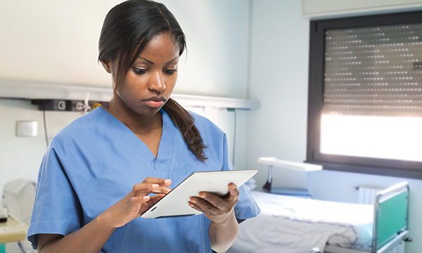 nurse consults tablet device